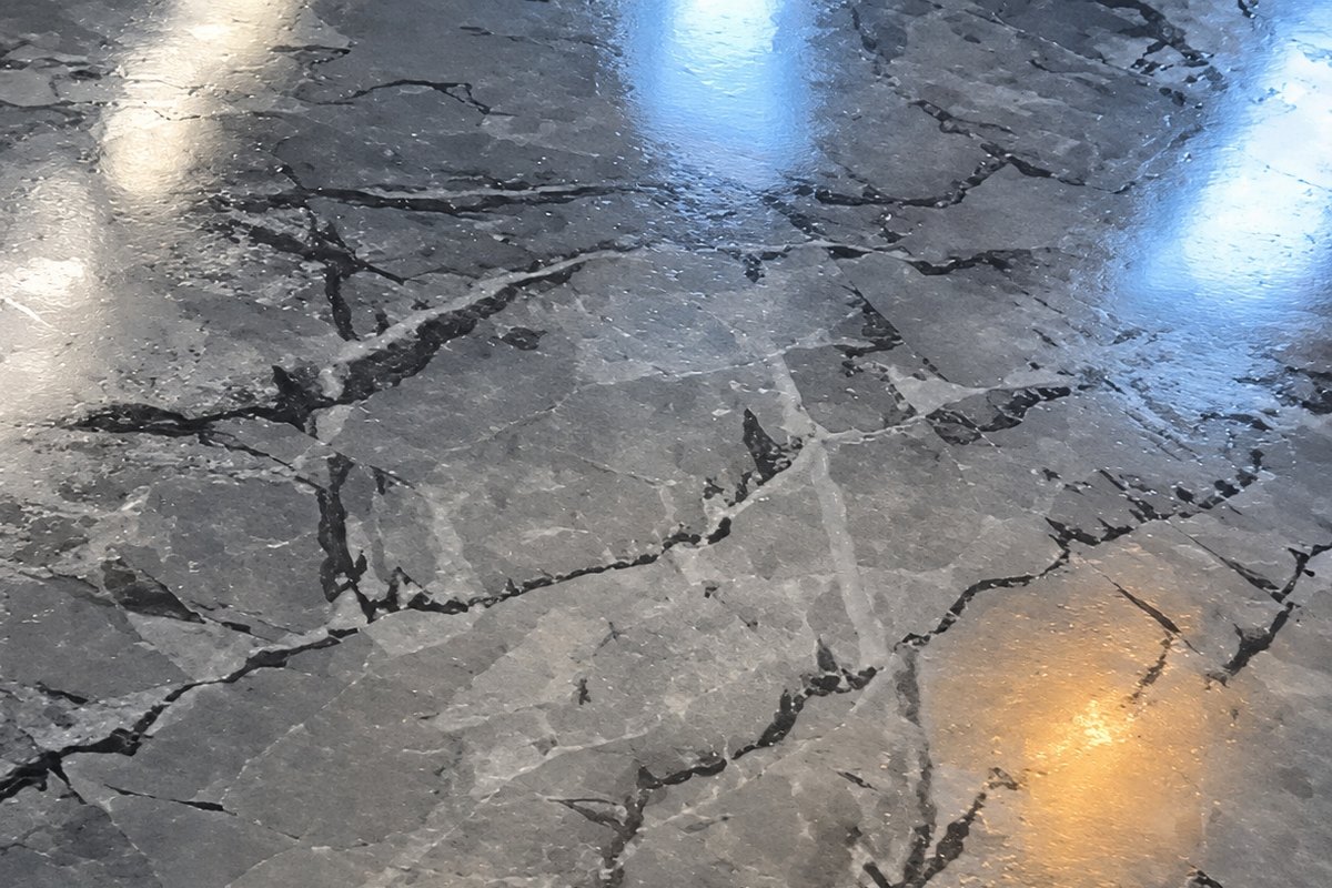 Glossy gray marble-look epoxy floor with black and white veining