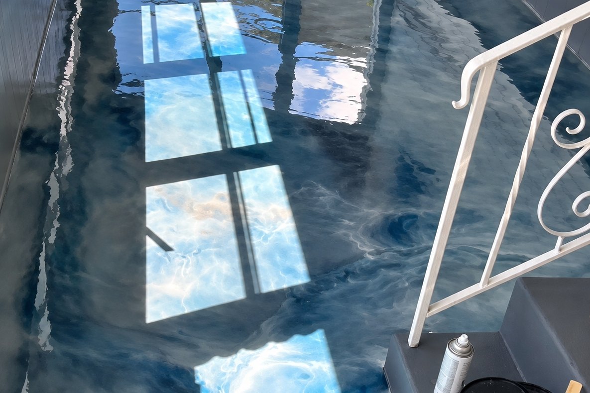 Swirled blue and white metallic epoxy coating on a long enclosed porch floor