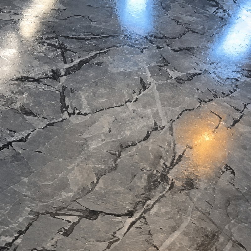 Glossy marble-look epoxy floor in gray with black and white veins, seen up close