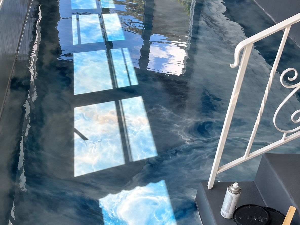 Long enclosed porch floor in high-gloss metallic epoxy swirled blue, white, and gray