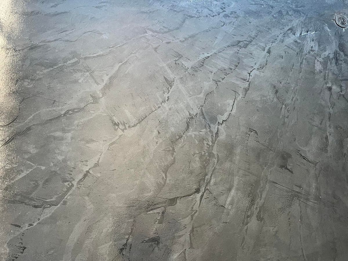 Close view of a metallic gray epoxy floor with pale marbled veining