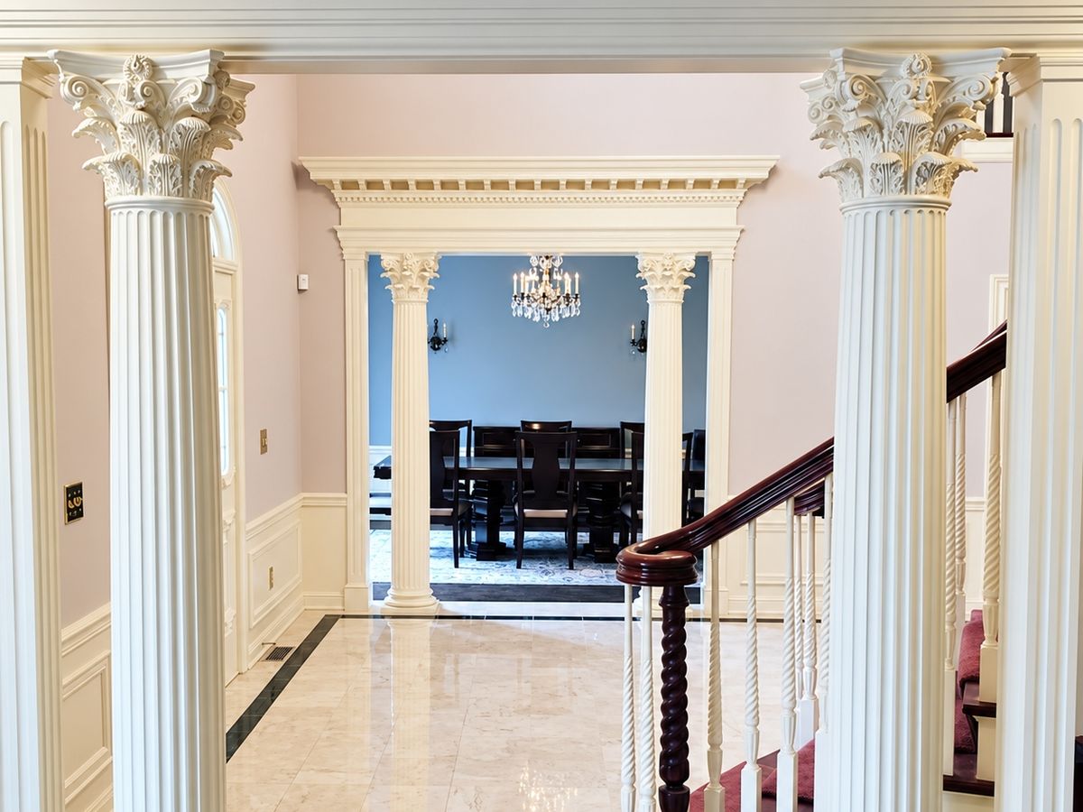 Front hall framed by two cream fluted Corinthian columns